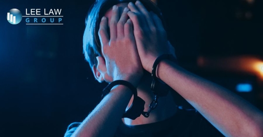 man being arrested with hands on his face