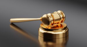 Warner Springs Human Trafficking Defense Attorney Canva Golden Hammer and Gavel 300x165